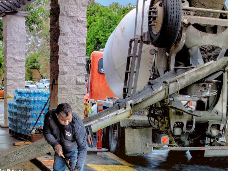 Concrete mixer truck pouring at a job site